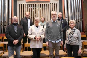 Eine Gruppe Menschen steht vor der alten Orgel in St. Marien